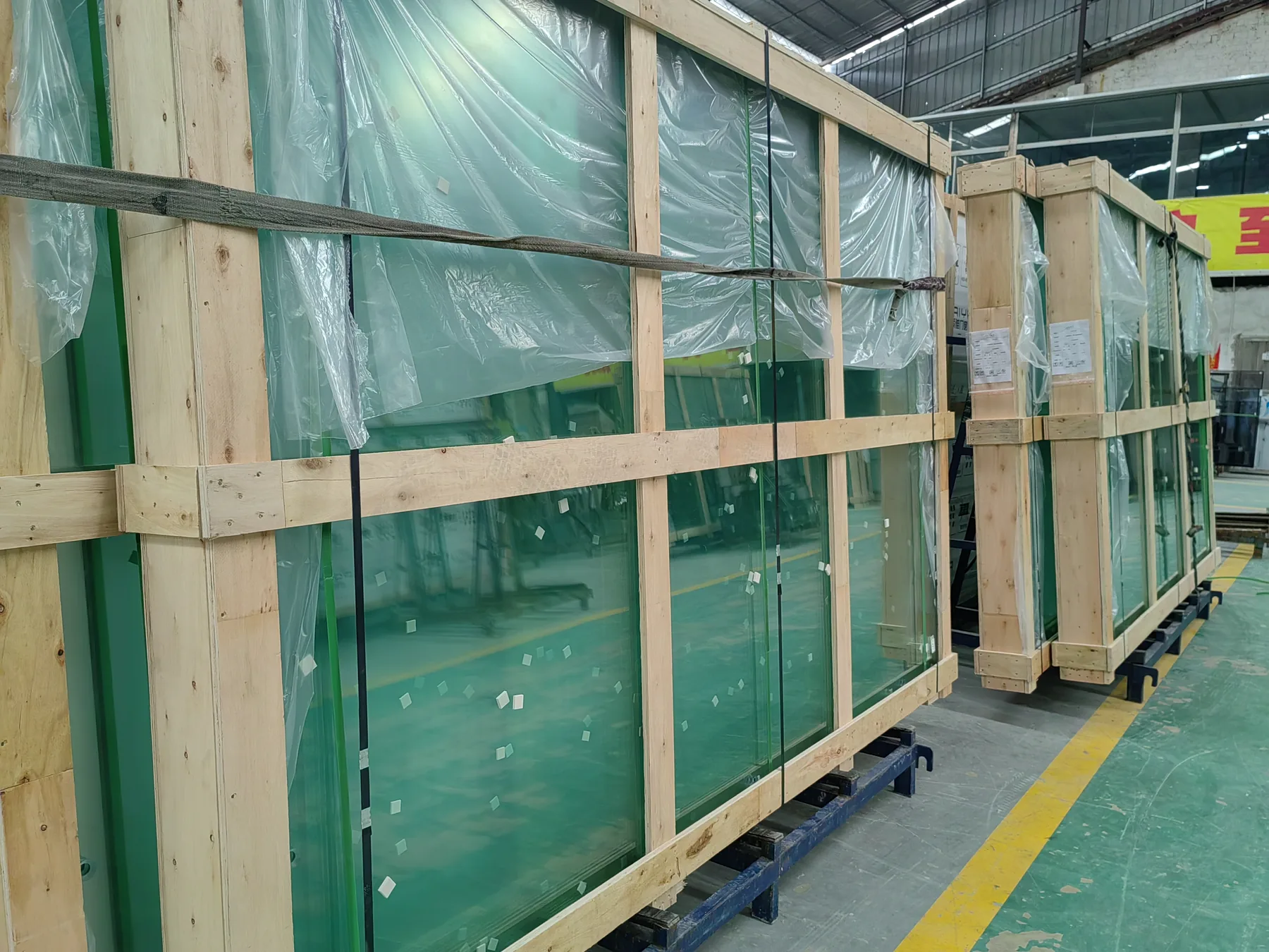 Tempered glass panels packed in wooden export crates for padel court shipment