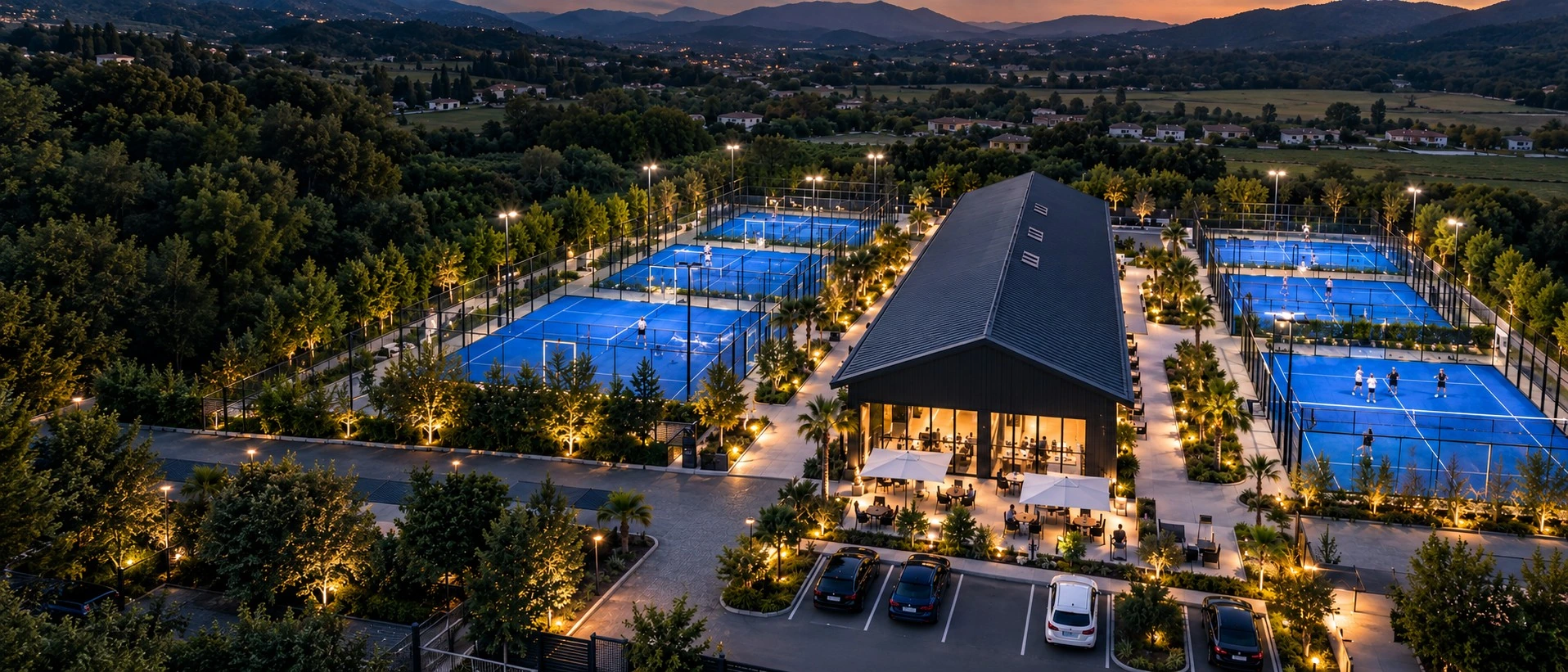 Commercial multi-court padel club with blue courts and a central clubhouse