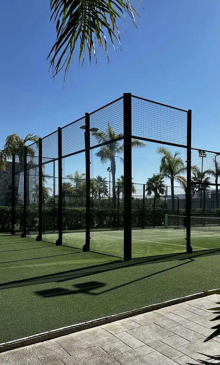 Outdoor padel courts among palm trees